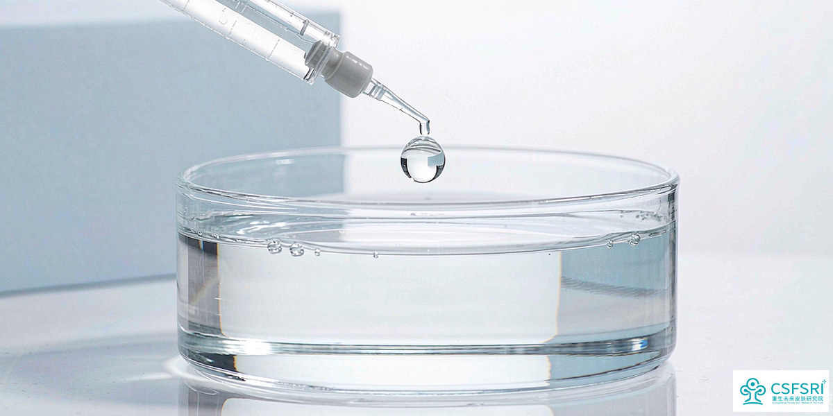 Cosmetic formulation bench with laboratory glassware and clear serum